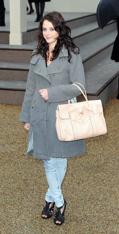 Woman in gray coat with handbag