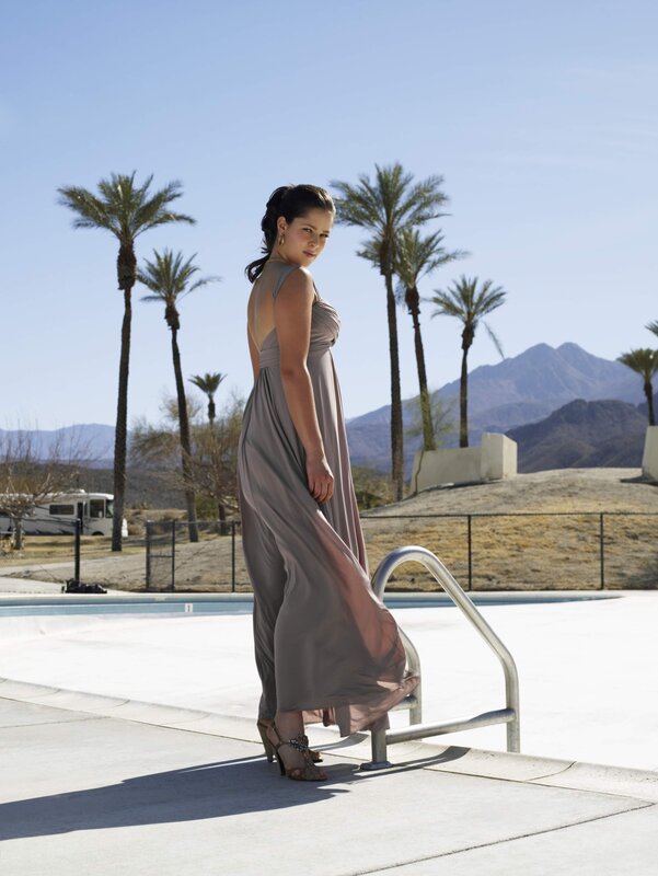 Woman in gray dress by pool