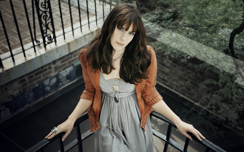 woman in gray dress on balcony