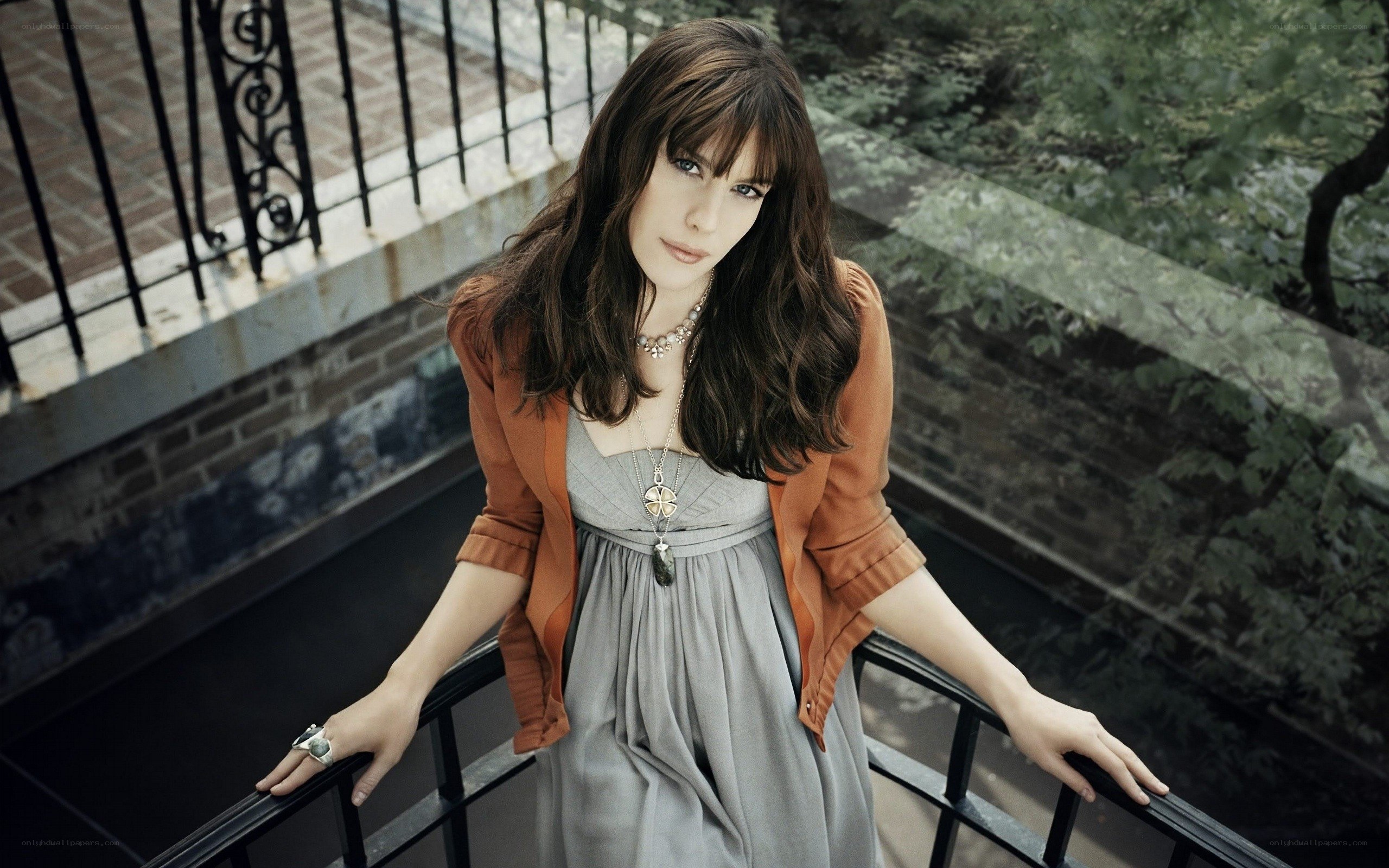 woman in gray dress on balcony