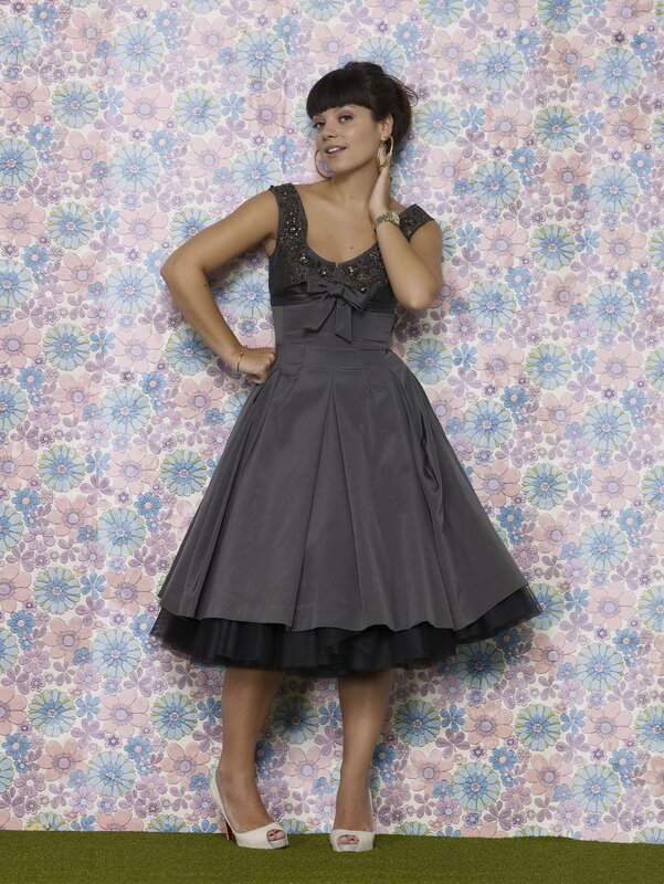 woman in gray dress posing