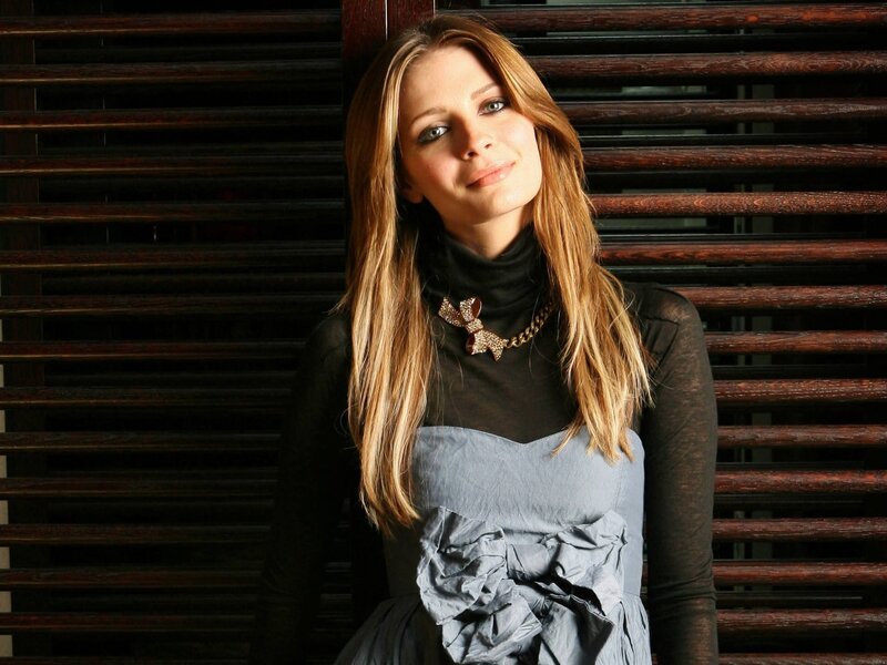 woman in gray dress with bow necklace