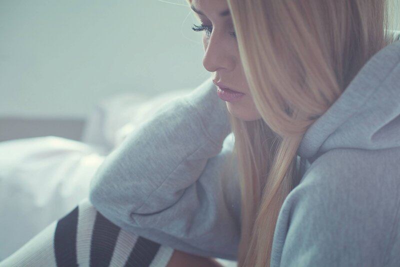 woman in gray hoodie sitting