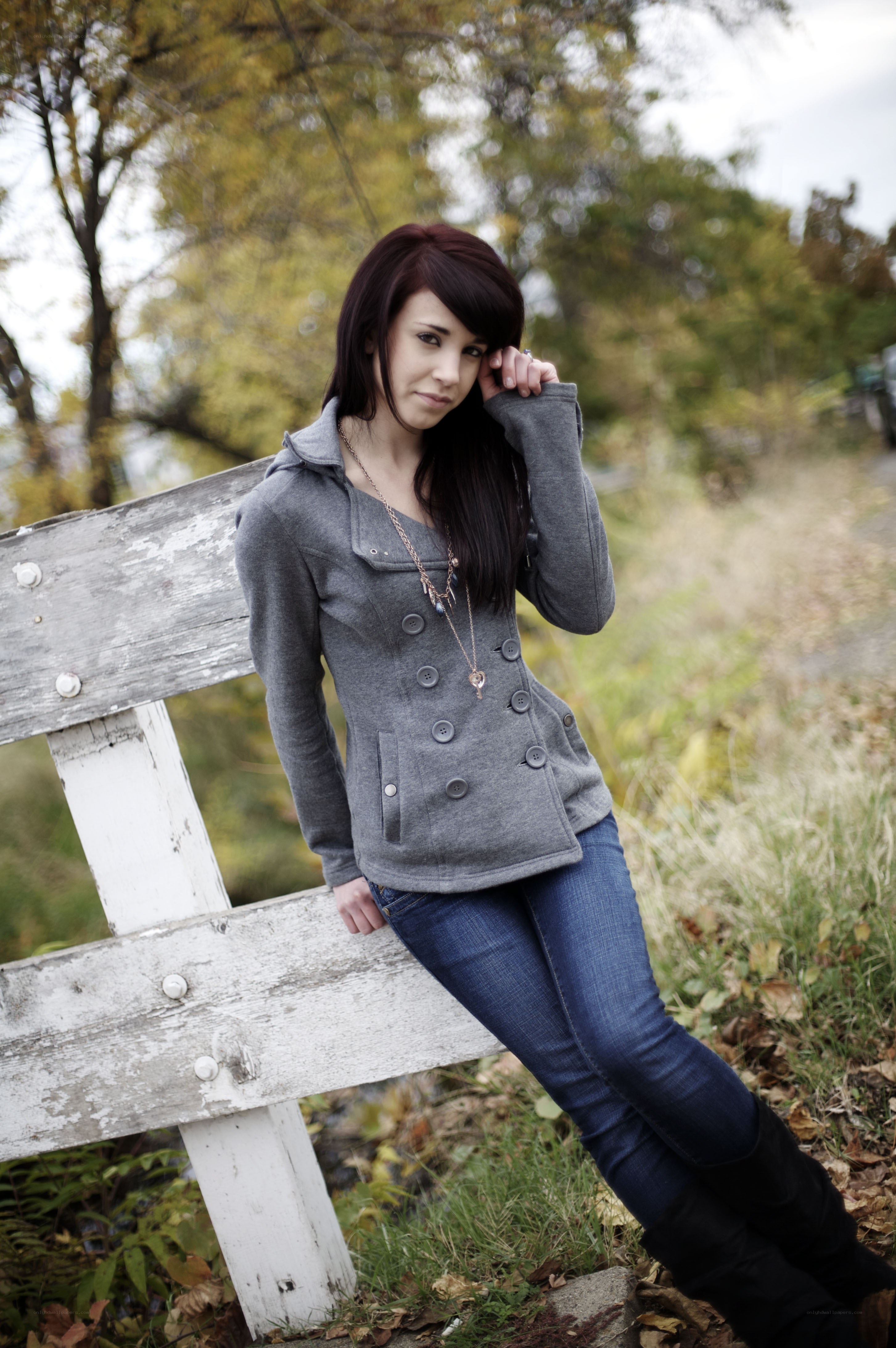 woman in gray jacket on bench