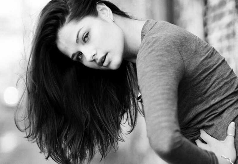 woman in gray shirt looking down