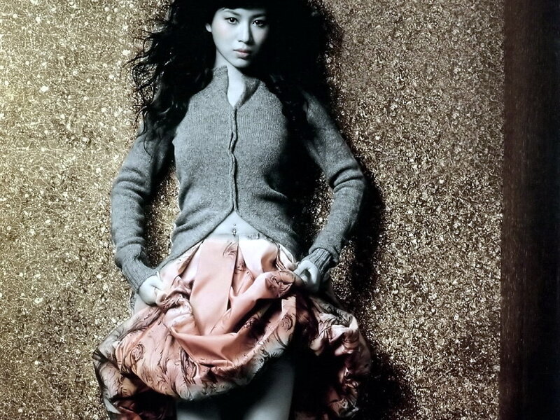 woman in gray sweater and pink skirt