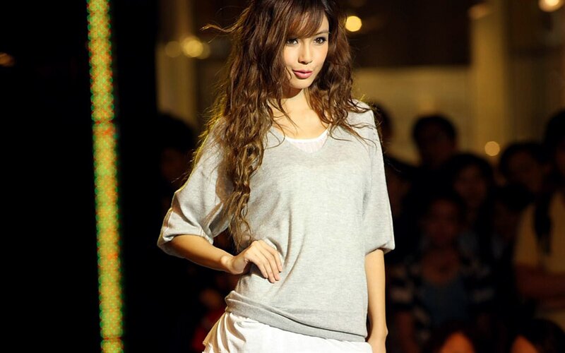 woman in gray sweater on runway