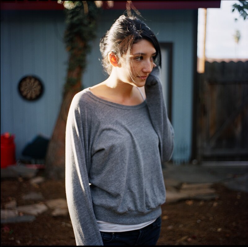 woman in gray sweater outdoors
