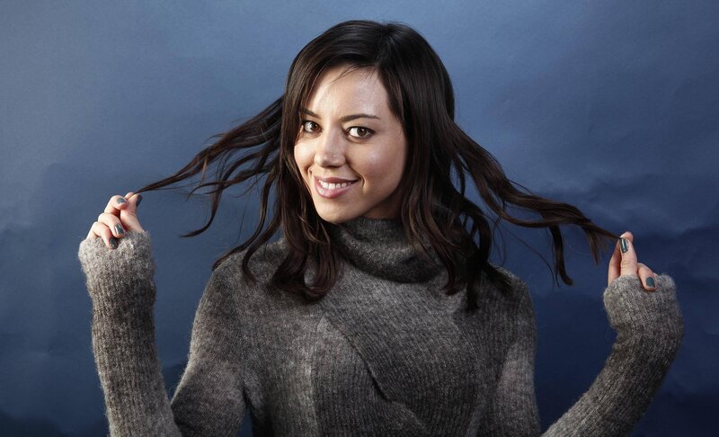 woman in gray sweater smiling