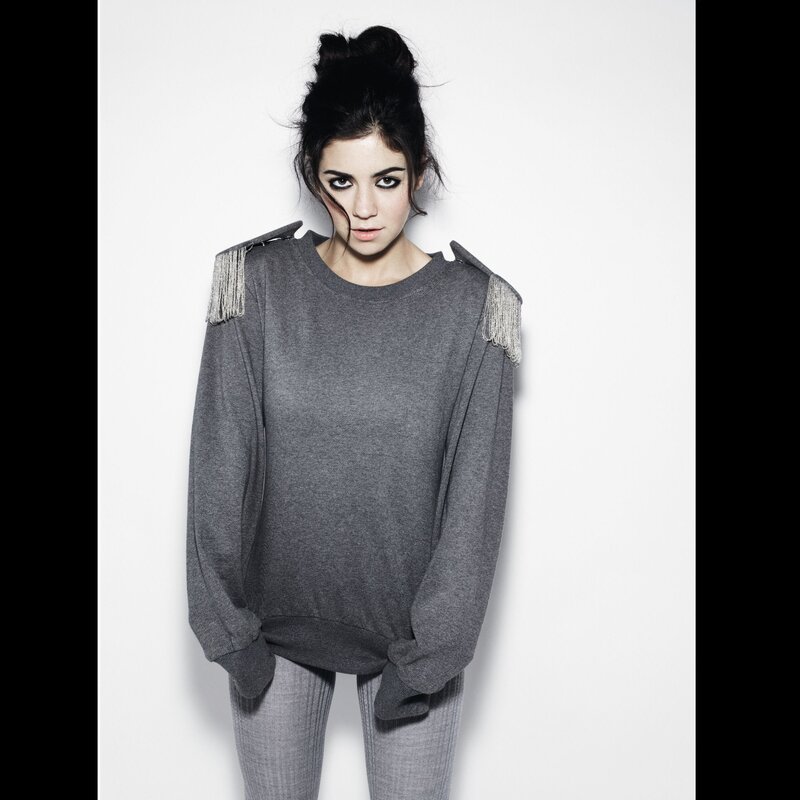 woman in gray sweater with fringe