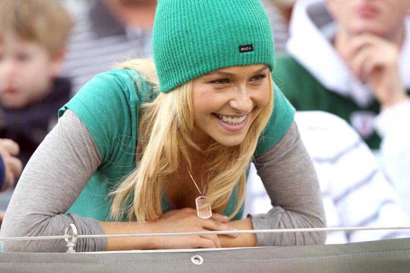 woman in green beanie smiling