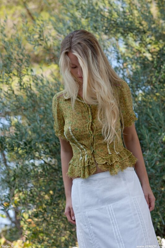 Woman in green blouse and white skirt