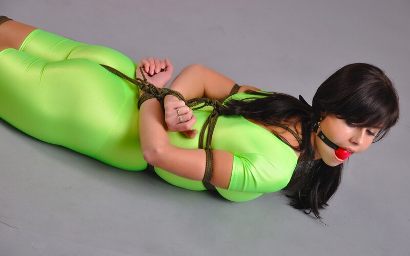 Woman in green bodysuit bound