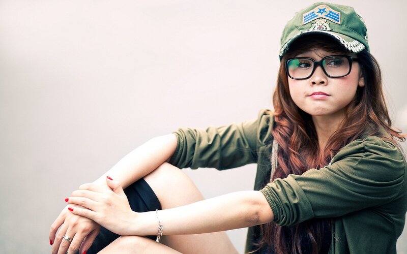 woman in green cap and glasses