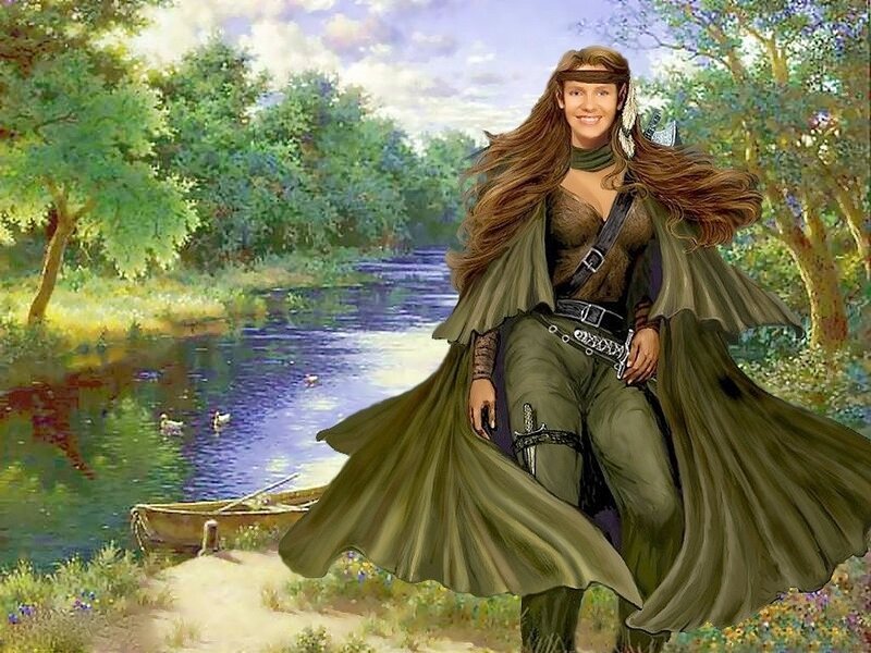 Woman in green cloak by river