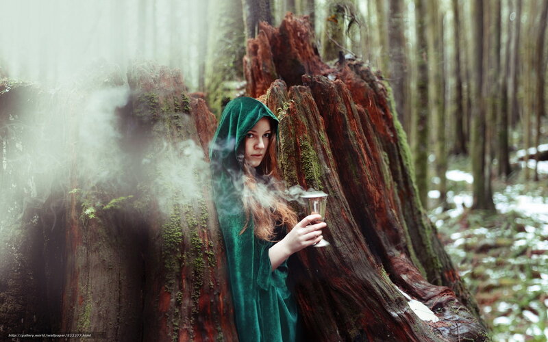 woman in green cloak forest