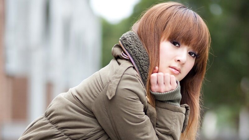 woman in green coat outdoors