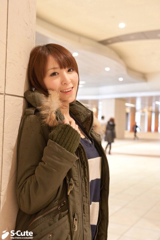 woman in green coat smiling