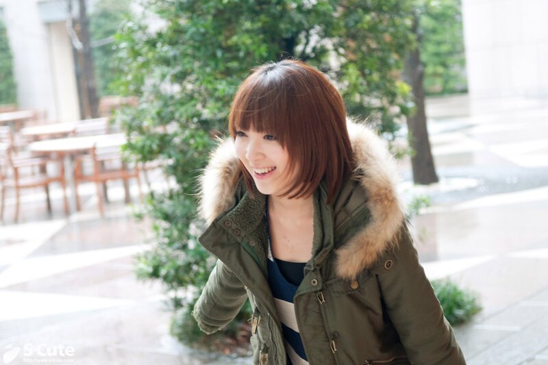 woman in green coat smiling