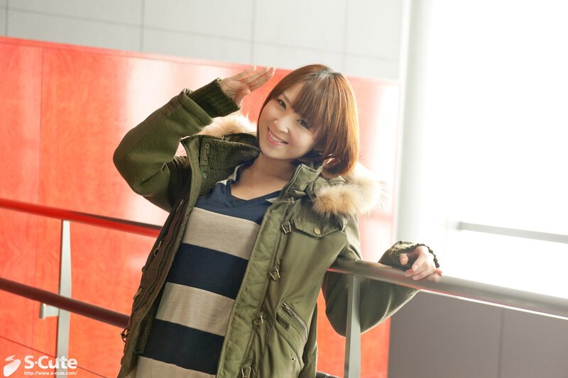 Woman in green coat waving