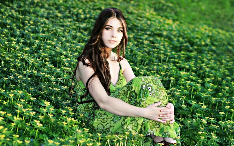 woman in green dress among flowers