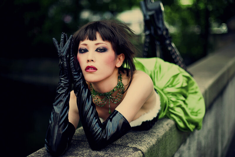 woman in green dress and black gloves