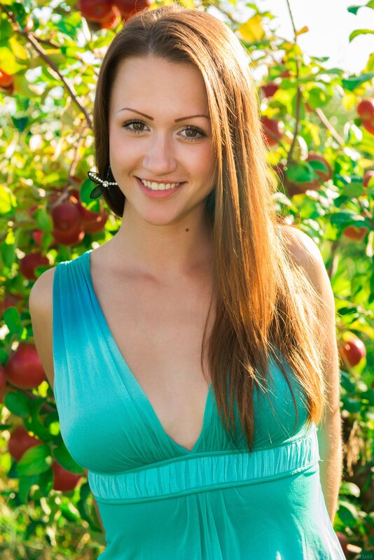 woman in green dress at apple orchard