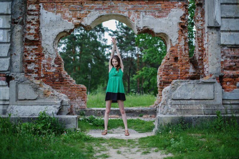 Woman in green dress at ruins
