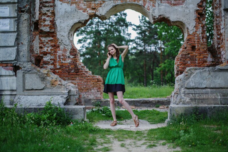 Woman in green dress at ruins