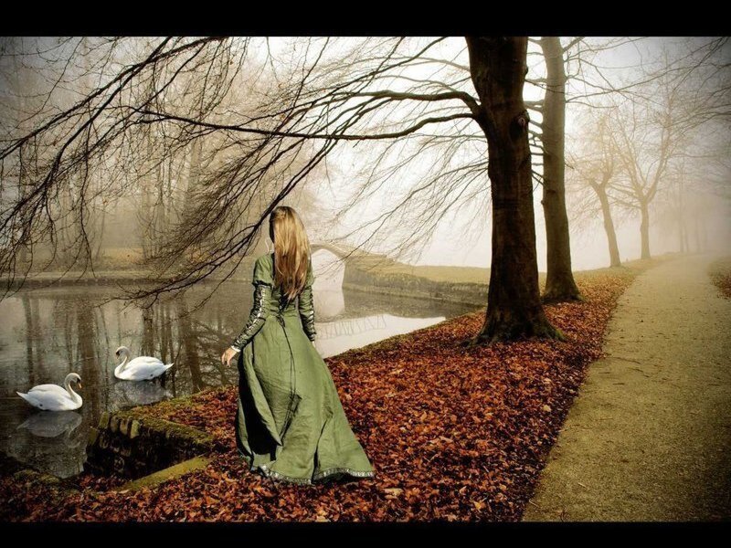 Woman in green dress by a lake