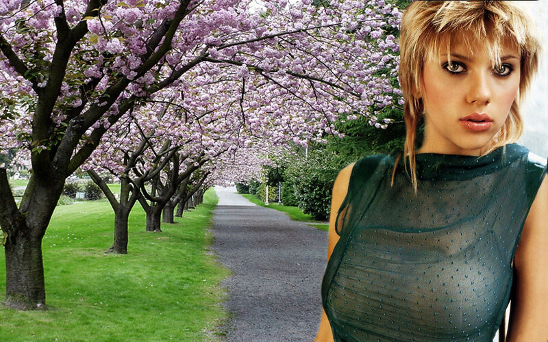 woman in green dress by cherry blossoms