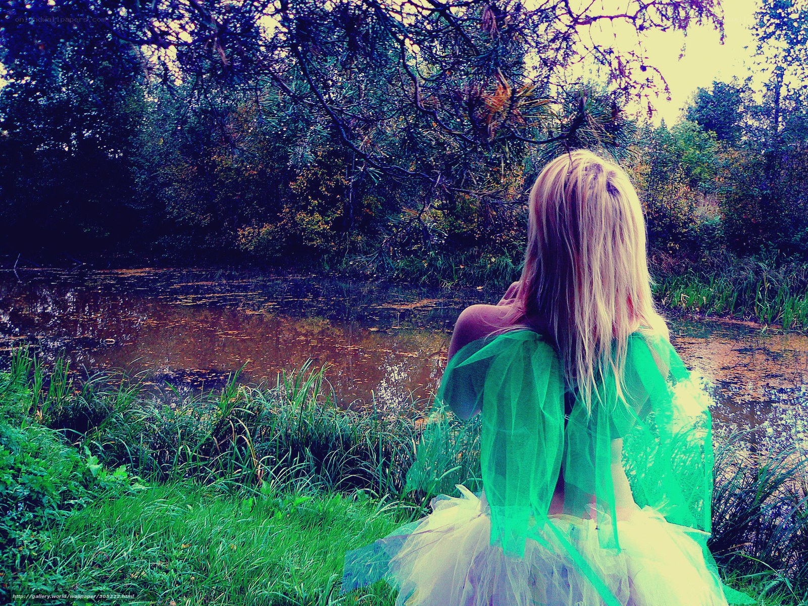 Woman in green dress by pond