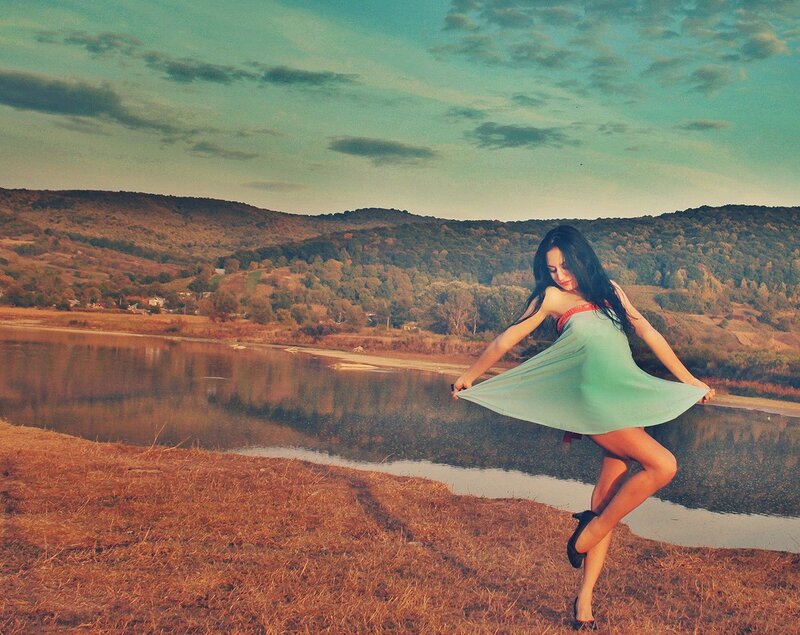 Woman in green dress by the river