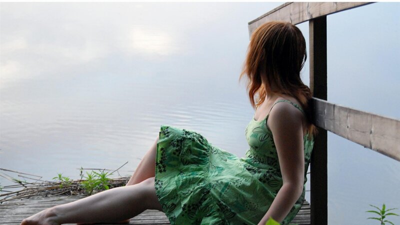 woman in green dress by the water