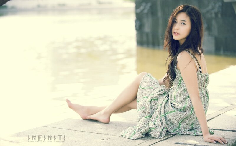 woman in green dress by water