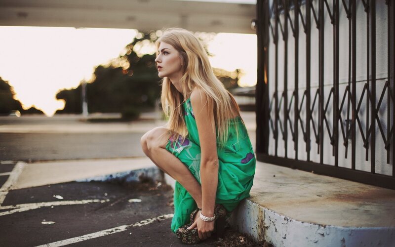 woman in green dress crouching