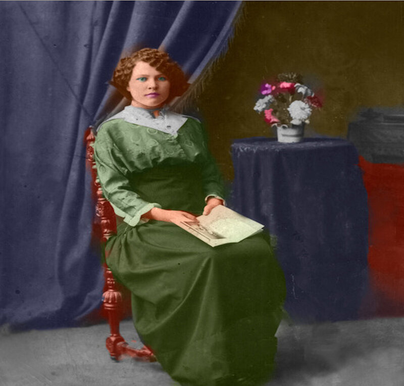 Woman in green dress holding book