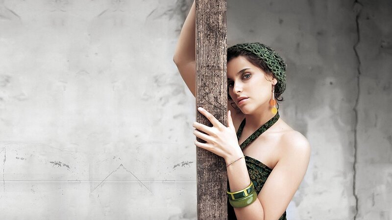 woman in green dress holding pole