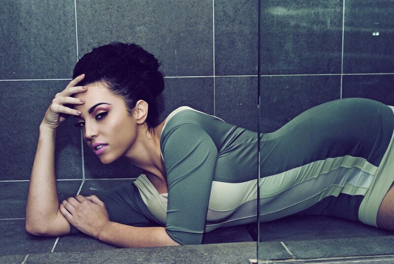 woman in green dress lying on floor