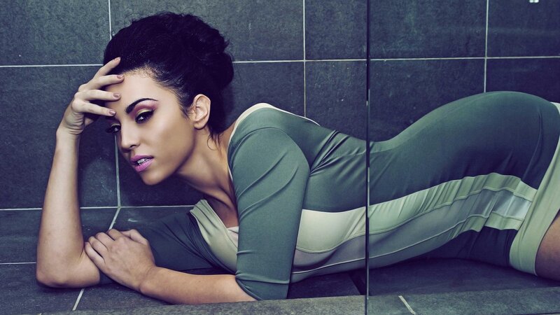 woman in green dress lying on floor