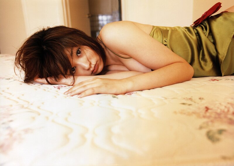 woman in green dress on bed