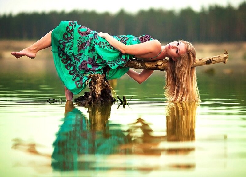 woman in green dress on log