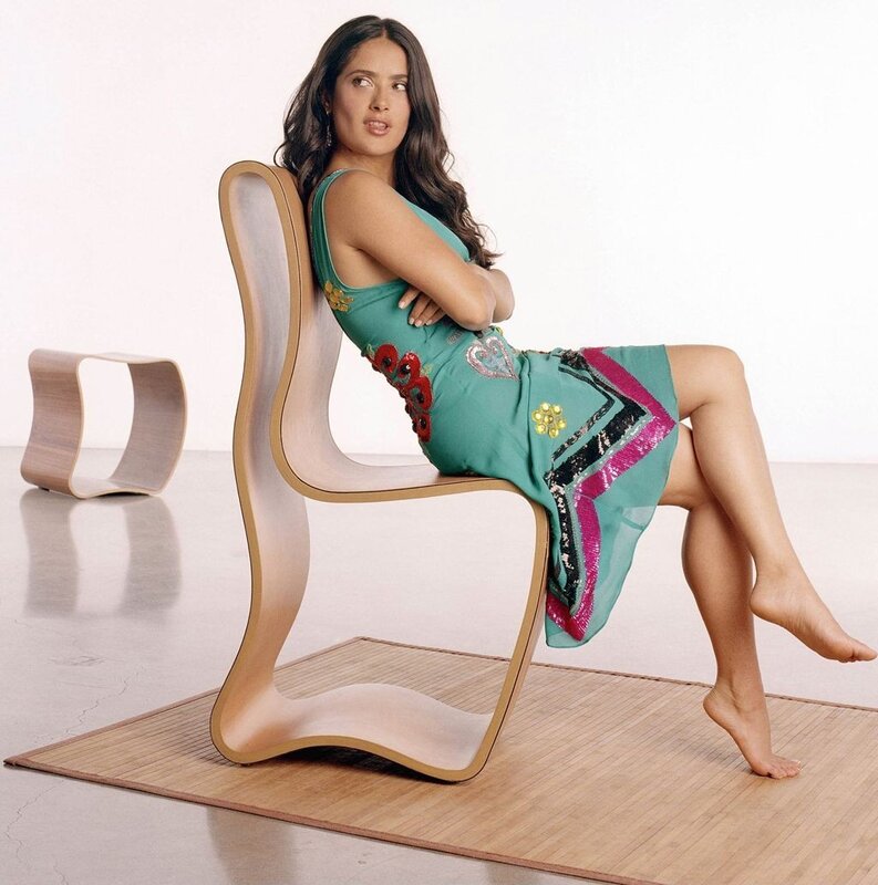 Woman in green dress on modern chair