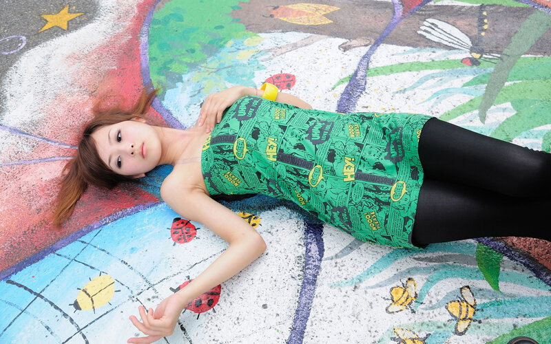 Woman in green dress on painted ground
