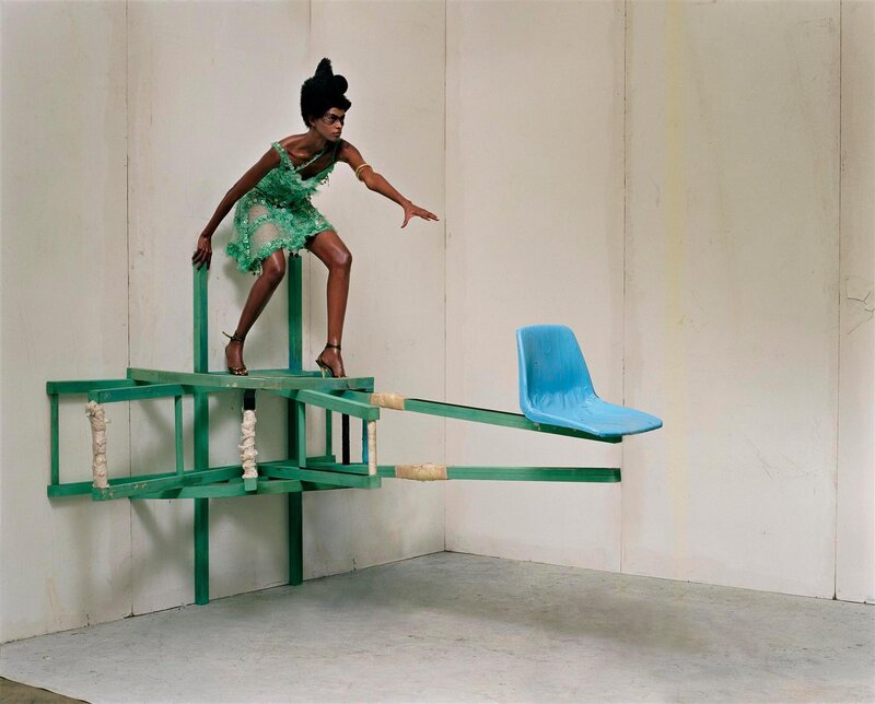 woman in green dress on sculpture