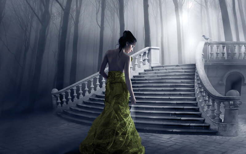 Woman in green dress on stone stairs