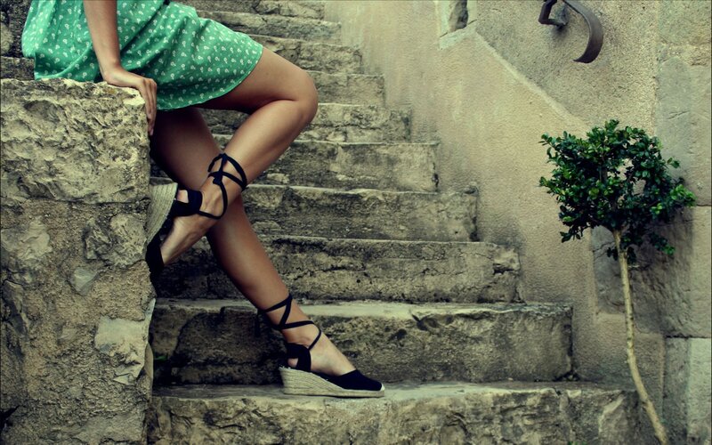 woman in green dress on stone stairs