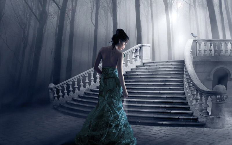 Woman in green dress on stone stairs