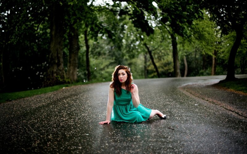 woman in green dress on wet road