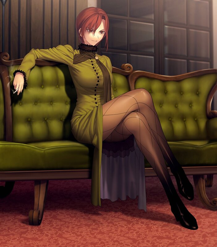 Woman in green dress sitting on couch